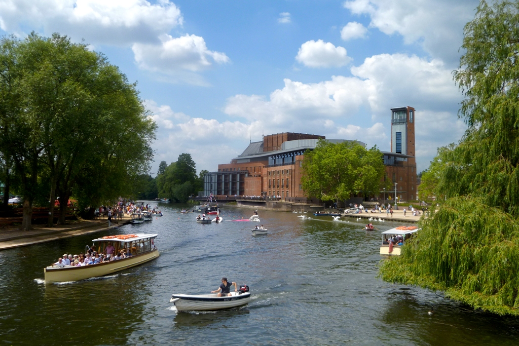Stratford River Festival showing small boats on river Avon and RSC in background