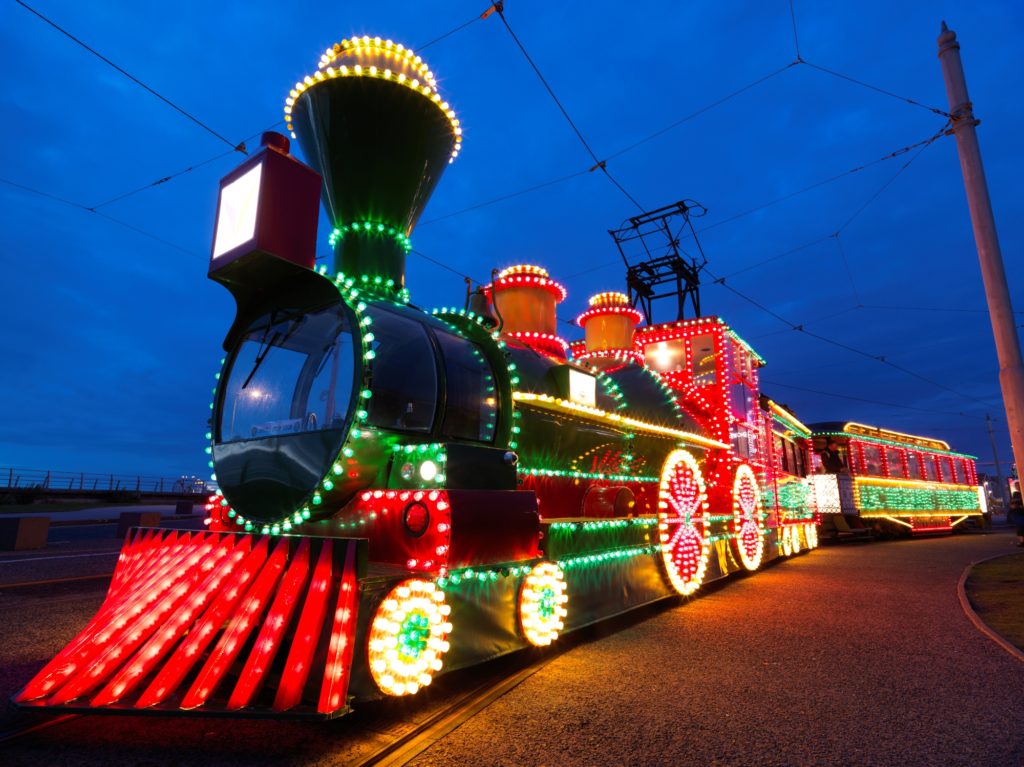 The Tram Train brightly illuminated in red, yellow and green lights