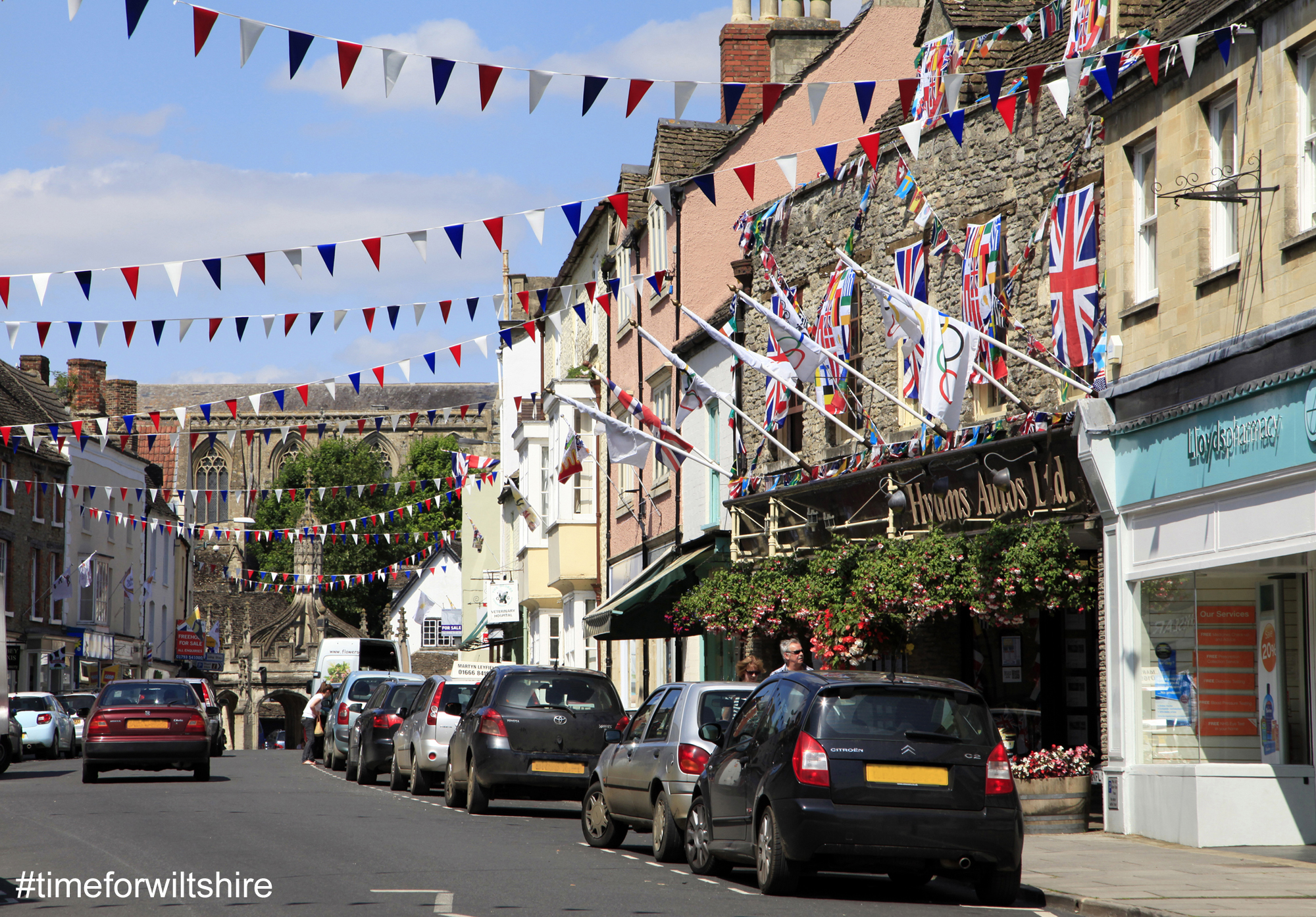 Shopping street with bunting flying Malmesbury © www.visitwiltshire.co.uk