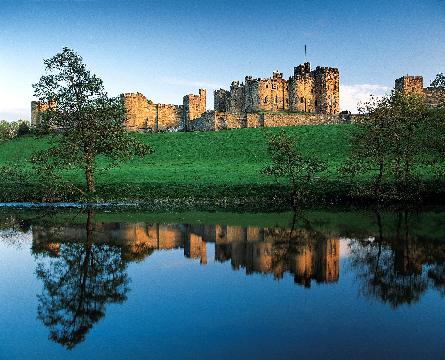 Castle reflected in the River Aln