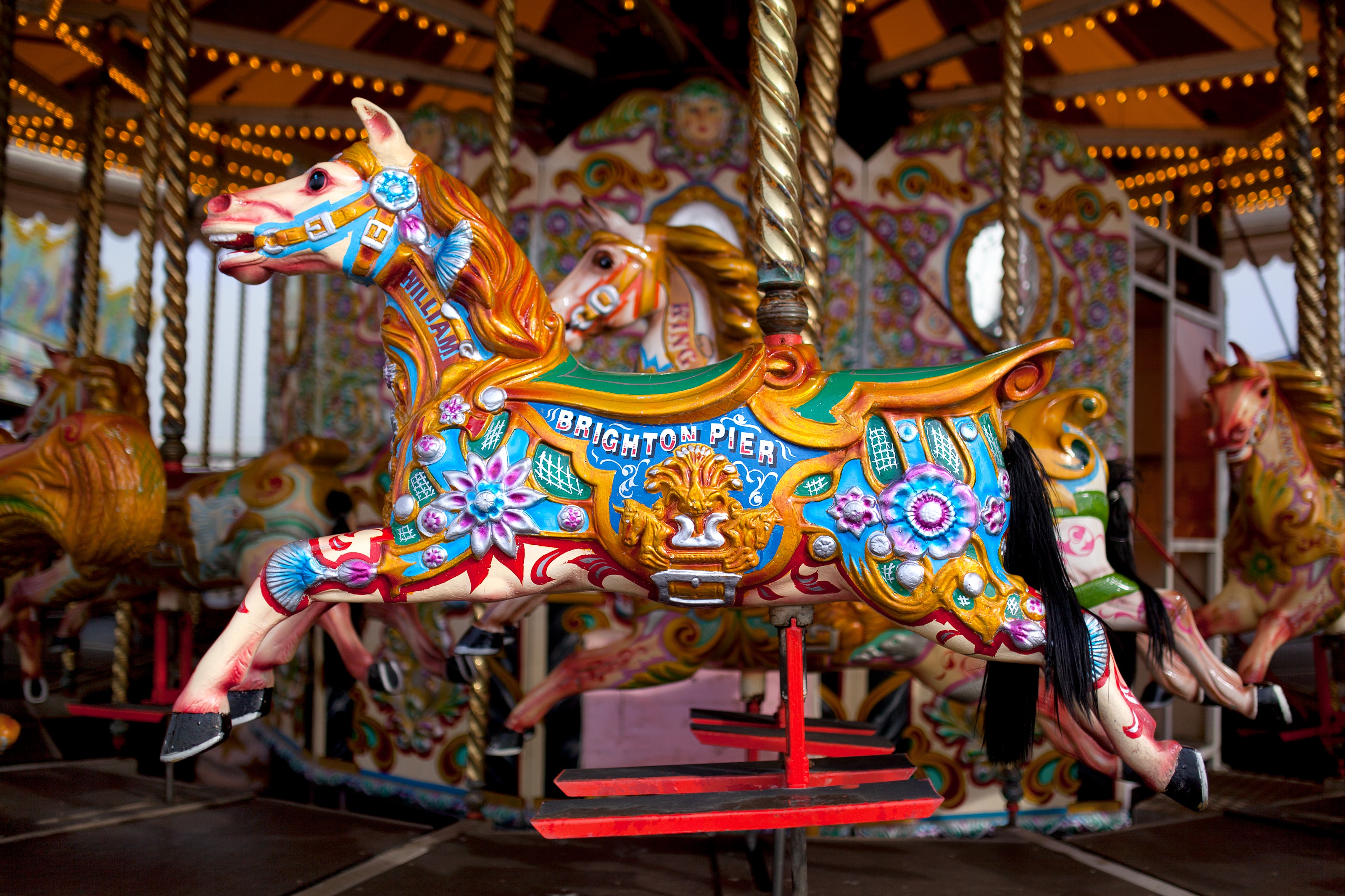 A merry-go-roung horse by Miles Storey on unsplash