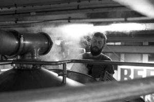 A man brewing beer in black and white 